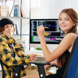 cheerful-pretty-teenage-girl-and-her-brother-smiling-at-camera-when-sitting-at-desk-and-doing-homework-for-computer-science-class cheerful-pretty-teenage-girl-and-her-brother-smiling-at-camera-when-sitting-at-desk-and-doing-homework-for-computer-science-class